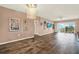 This living room features hard floors, a chandelier, wall decor, a ceiling fan, and a sliding glass door at 1200 N Shore Ne Dr # 404, St Petersburg, FL 33701