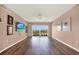 This living room features hard floors, wall decor, a ceiling fan, and a sliding glass door at 1200 N Shore Ne Dr # 404, St Petersburg, FL 33701