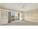 This living room features carpet, built-in shelving, and a sliding glass door leading to an outdoor balcony at 1200 N Shore Ne Dr # 404, St Petersburg, FL 33701