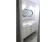 Bathroom with white vanity, dual sinks, and decorative tile backsplash at 1200 Tarpon Woods Blvd # M6, Palm Harbor, FL 34685