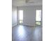 A spacious bedroom with stylish tile flooring, natural lighting, and a ceiling fan at 1200 Tarpon Woods Blvd # M6, Palm Harbor, FL 34685