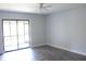A spacious bedroom with tiled floors and natural light leading to a screened balcony at 1200 Tarpon Woods Blvd # M6, Palm Harbor, FL 34685
