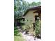 Landscaped front entrance with stone walkway, shrubs, and low voltage lighting at 1200 Tarpon Woods Blvd # M6, Palm Harbor, FL 34685