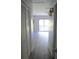 Hallway featuring tiled floors and access to a closet and living space at 1200 Tarpon Woods Blvd # M6, Palm Harbor, FL 34685