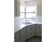 Modern kitchen featuring sleek countertops, stainless steel sink, and classic white subway tile backsplash at 1200 Tarpon Woods Blvd # M6, Palm Harbor, FL 34685
