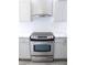 Updated kitchen featuring modern stainless steel range and hood at 1200 Tarpon Woods Blvd # M6, Palm Harbor, FL 34685
