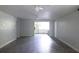 Spacious living room with tile flooring and adjacent open kitchen concept at 1200 Tarpon Woods Blvd # M6, Palm Harbor, FL 34685