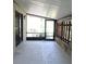 Enclosed patio features stone accents, concrete flooring and backyard access at 1200 Tarpon Woods Blvd # M6, Palm Harbor, FL 34685