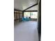 An outdoor porch with blue chairs overlooking a pond at 1200 Tarpon Woods Blvd # M6, Palm Harbor, FL 34685