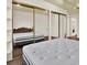 This bedroom offers a comfortable mattress and mirrored closet at 1206 10Th Se Cir, Largo, FL 33771