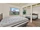 Comfortable main bedroom with a large window and laminate flooring at 1206 10Th Se Cir, Largo, FL 33771