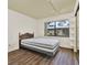 Well-lit main bedroom features a large window and laminate flooring at 1206 10Th Se Cir, Largo, FL 33771