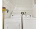 Laundry room with dryer, washing machine and shelves at 1206 10Th Se Cir, Largo, FL 33771