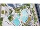 Aerial view showcases a luxurious double pool area with lush tropical landscaping and nearby tower at 1209 E Cumberland Ave # 1003, Tampa, FL 33602