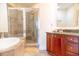Bathroom with a tub, separate shower, and a granite-topped vanity at 1209 E Cumberland Ave # 1003, Tampa, FL 33602