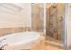 Bright bathroom featuring a bathtub and tiled shower with glass door at 1209 E Cumberland Ave # 1003, Tampa, FL 33602