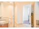 Modern bathroom featuring a glass shower, dual vanity sinks, and a view into a bedroom at 1209 E Cumberland Ave # 1003, Tampa, FL 33602