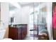 Bathroom featuring a dark wood vanity with granite counters and shower with glass doors at 1209 E Cumberland Ave # 1003, Tampa, FL 33602