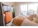 Bright bedroom with large windows, a dresser with a TV and city views at 1209 E Cumberland Ave # 1003, Tampa, FL 33602