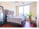 Bedroom with a large window, wooden floors, and a cozy chair at 1209 E Cumberland Ave # 1003, Tampa, FL 33602