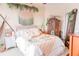 Comfortable bedroom with a cozy bed, a vintage wardrobe and decorative elements at 1209 E Cumberland Ave # 1003, Tampa, FL 33602