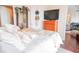 Bright bedroom with comfy bed, wooden dresser and mirror at 1209 E Cumberland Ave # 1003, Tampa, FL 33602