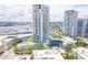 Aerial view of white high-rise towers with private balconies and a beautiful pool and manicured grounds at 1209 E Cumberland Ave # 1003, Tampa, FL 33602