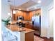 Modern kitchen featuring granite countertops, stainless steel appliances, and wooden cabinetry at 1209 E Cumberland Ave # 1003, Tampa, FL 33602