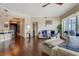 The bright living room boasts hardwood floors, offering comfortable seating, and access to outdoor balcony at 1209 E Cumberland Ave # 1003, Tampa, FL 33602