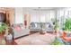 Bright living room featuring cozy seating, plants, and a large window with natural light at 1209 E Cumberland Ave # 1003, Tampa, FL 33602