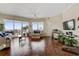 Bright living room featuring wood floors, large windows with city views, and comfortable seating at 1209 E Cumberland Ave # 1003, Tampa, FL 33602