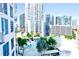 Condo's pool with city backdrop with palm trees at 1209 E Cumberland Ave # 1003, Tampa, FL 33602
