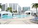 Condo's pool with city backdrop and various lounge seating at 1209 E Cumberland Ave # 1003, Tampa, FL 33602