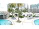 Inviting pool with lounge chairs, palm trees, and covered seating areas for ultimate relaxation at 1209 E Cumberland Ave # 1003, Tampa, FL 33602