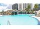 Resort-style pool featuring a rock waterfall and plenty of lounge chairs for relaxing at 1209 E Cumberland Ave # 1003, Tampa, FL 33602