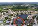 Overhead shot of a suburban home with a screened pool, lush surroundings, and a peaceful pond nearby at 1218 Willow Bend Way, Lutz, FL 33549