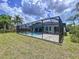 Spacious backyard with a screened-in pool, lush green grass, and privacy fencing, perfect for outdoor activities at 1218 Willow Bend Way, Lutz, FL 33549