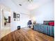 Spare bedroom with hardwood floors, window with blinds, closet, and office chair at 1218 Willow Bend Way, Lutz, FL 33549