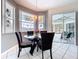 Bright dining area features tile floors, neutral paint, modern lighting, and windows overlooking lanai at 1218 Willow Bend Way, Lutz, FL 33549