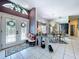 Inviting foyer with decorative glass doors, tile flooring, and view into dining area at 1218 Willow Bend Way, Lutz, FL 33549