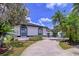 Well-maintained home featuring beautiful landscaping, a curved driveway, and an attached garage at 1218 Willow Bend Way, Lutz, FL 33549