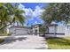 Charming single-story home featuring a two-car garage, manicured landscaping, and a welcoming front entrance at 1218 Willow Bend Way, Lutz, FL 33549