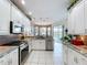 Modern kitchen with granite countertops, stainless steel appliances, and backyard view at 1218 Willow Bend Way, Lutz, FL 33549