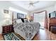 Spacious main bedroom with hardwood floors, fan, and glass sliding door to pool area at 1218 Willow Bend Way, Lutz, FL 33549