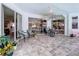 Covered patio with comfortable seating, decorative plants, and sliding glass doors that lead to the interior at 1218 Willow Bend Way, Lutz, FL 33549