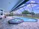 Relaxing pool and spa area with a screened enclosure, offering privacy and a serene outdoor experience at 1218 Willow Bend Way, Lutz, FL 33549