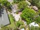 Aerial view of a property with a lush, green backyard, featuring a charming swing set and patio area, perfect for outdoor enjoyment at 1226 E Henry Ave, Tampa, FL 33604