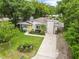 An aerial view of a cozy home boasting lush landscaping, complemented by a long driveway at 1226 E Henry Ave, Tampa, FL 33604
