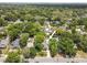 Aerial view of a quaint home surrounded by lush greenery, providing a private and peaceful setting at 1226 E Henry Ave, Tampa, FL 33604