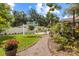 Charming backyard featuring a swing, gravel path, and lush landscaping at 1226 E Henry Ave, Tampa, FL 33604